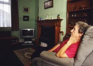 Elderly woman sitting in an armchair