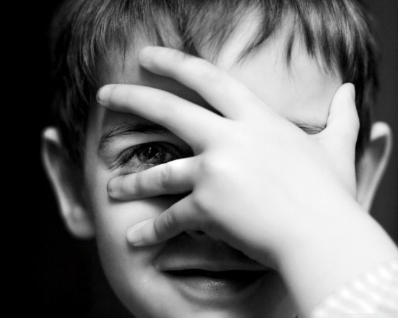 child-covering-face